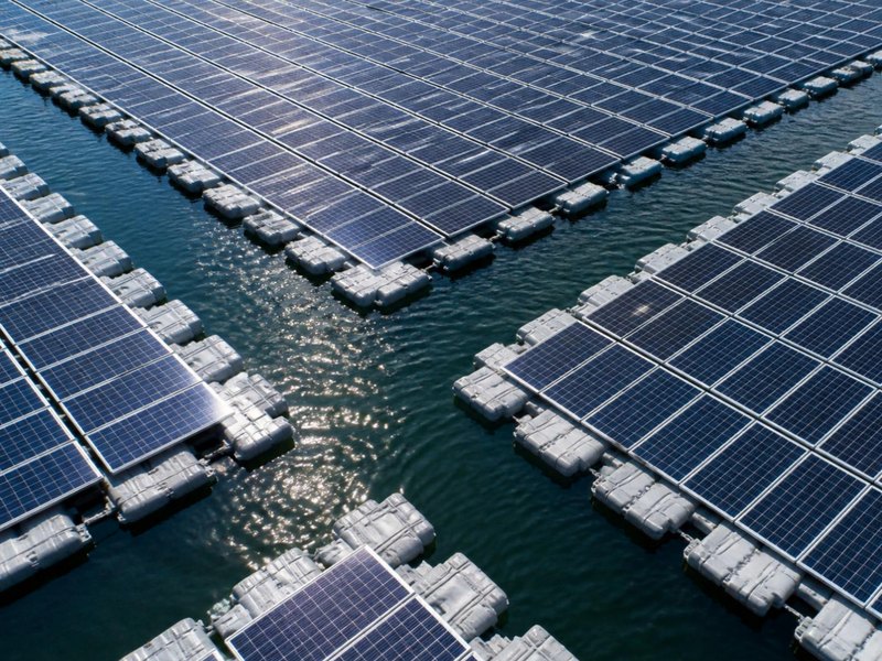 Conceptual rendering of an aerial view of floating array blocks and floats — concept visual, not the Goldasht site